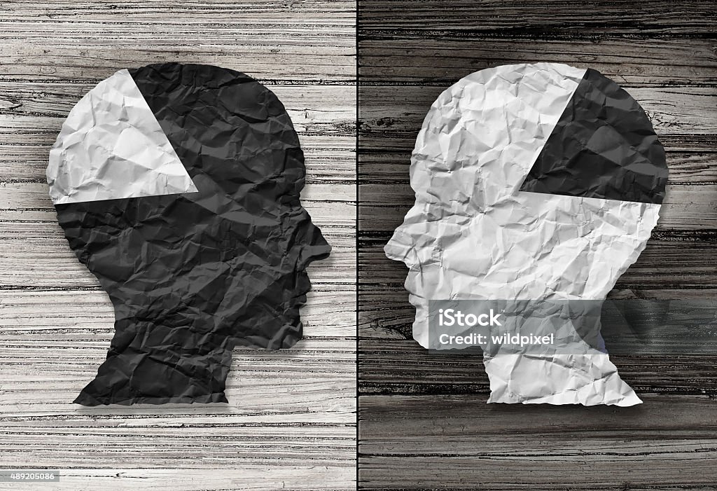 Ethnic Equality Ethnic equality concept and racial justice symbol as a black and white crumpled paper shaped as a human head on old rustic wood background with contrasting tones as a metaphor for social race issues. Racism Stock Photo