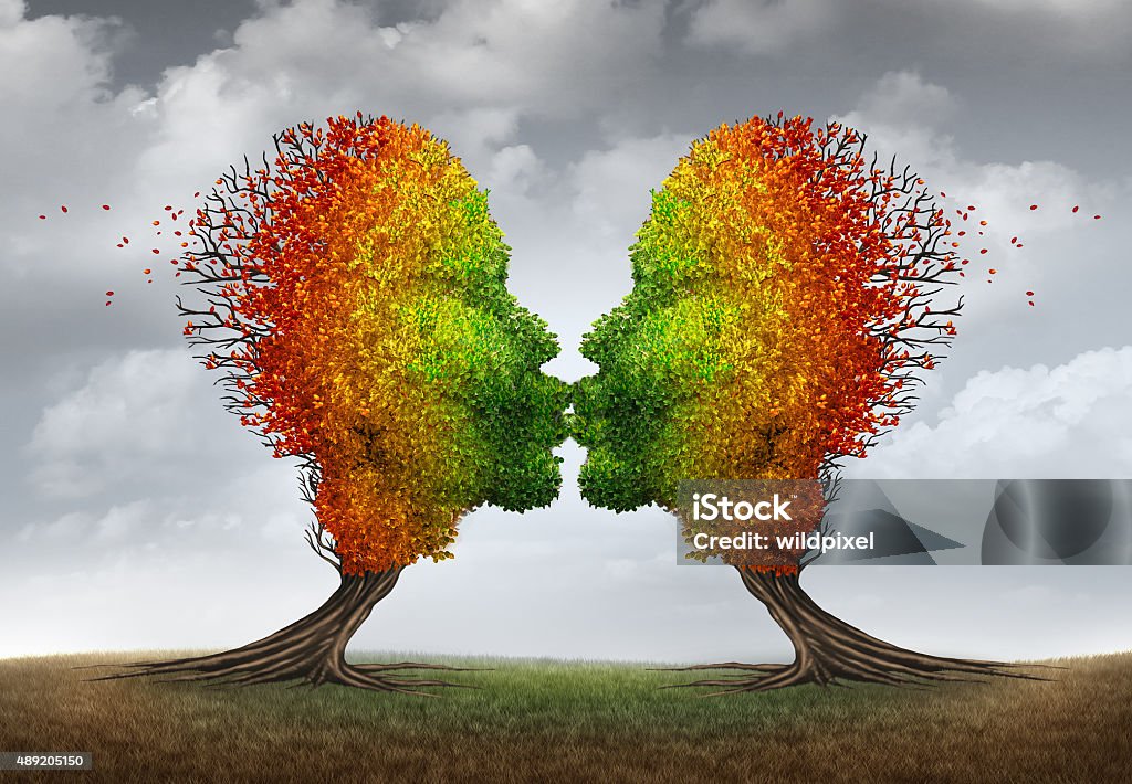 Aging Couple Aging couple relationship symbol and losing sex drive concept or low sexual desire metaphor as two trees shaped as kissing human heads losing leaves as in autumn season. 2015 Stock Photo