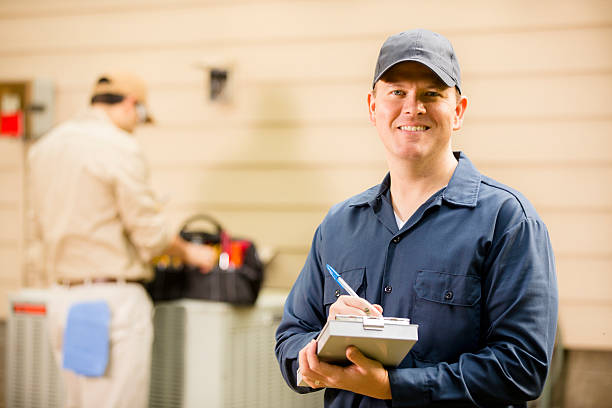 istock Air conditioner repairmen work on home unit. Blue collar workers. 489205154