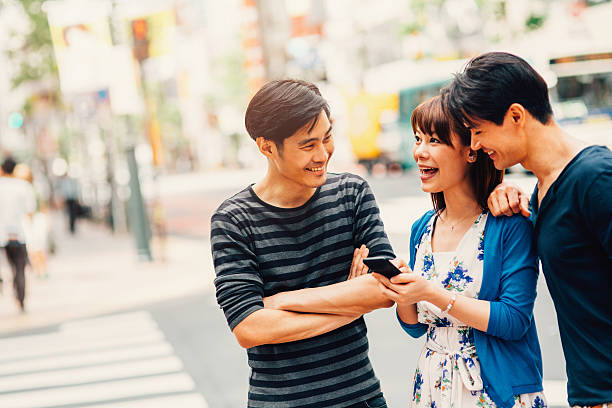 istock Happy japanese friends surfing the net 489205772