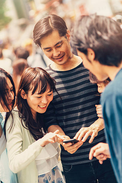 istock Happy japanese friends surfing the net 489205788
