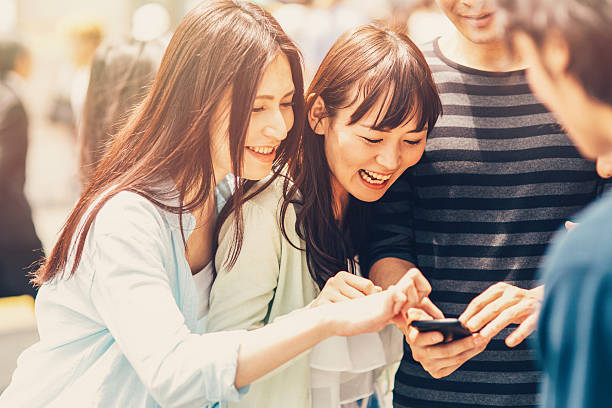 istock Happy japanese friends surfing the net 489205806