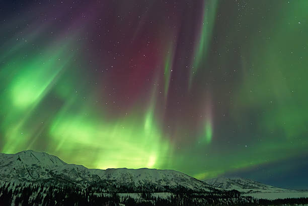 istock Aurora Borealis over snow capped mountains 489206004
