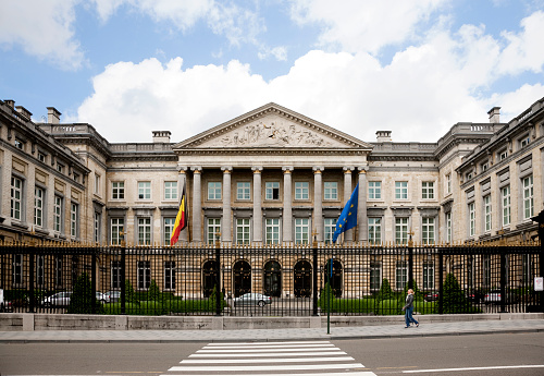 Brussels, Belgium -- June 6, 2012: Facade of the Belgian Parliament Building, one person is walking along the fence