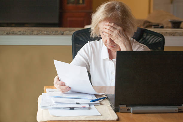 istock Senior woman looking her mounting bills 489206646