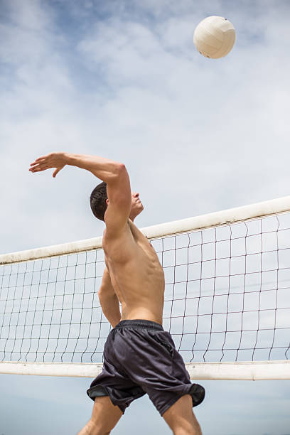 istock Volleyball player spiking ball against opposing team 489207518