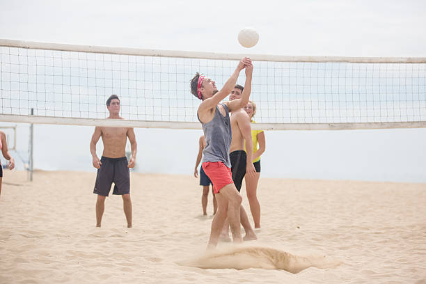 istock Group of friends playing beach volleyball 489207656