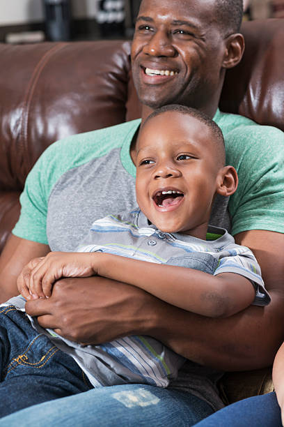 istock African American father and son on couch watching tv 489207744