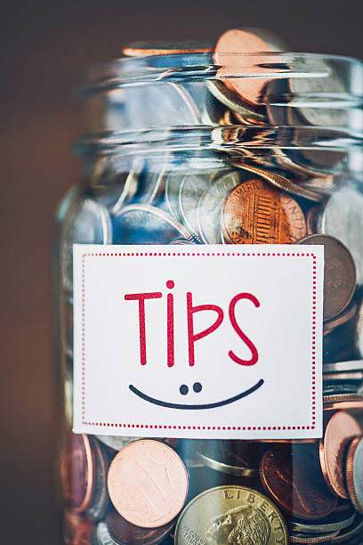 istock Tip jar with American currency on brown background 489210868