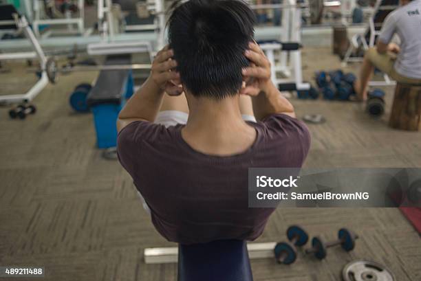 Young Man Exercising Doing Situps Indoors For Diet Stock Photo - Download Image Now