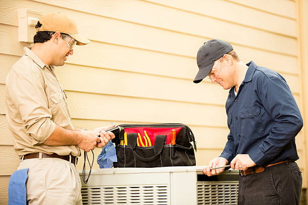 istock Air conditioner repairmen work on home unit. Blue collar workers. 489211824