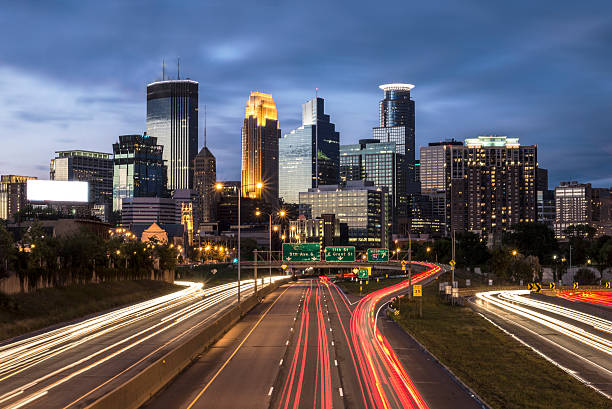 istock Minneapolis City Skyline at Night and Traffic Light Tails 489213156