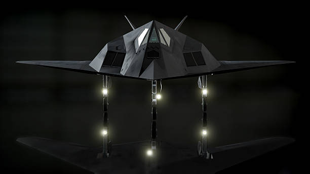Stealth Fighter in Dark Hanger Image of stealth fighter in dark hanger with reflection on floor. military deployment photos stock pictures, royalty-free photos & images