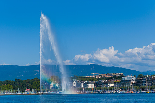 Woman having fun with water next to fountain.