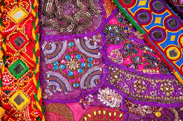 Colorful ethnic Rajasthan cushion cover and belts with mirrors on flea market in India