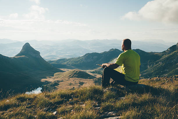istock Man with a map on top of the mountain. 489214592