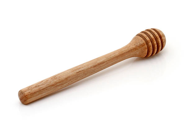 wooden honey stick isolated stock photo