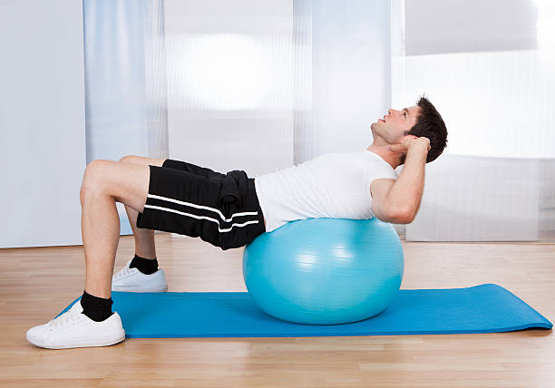 istock Man Doing Sit Ups On Fitness Ball 489220507