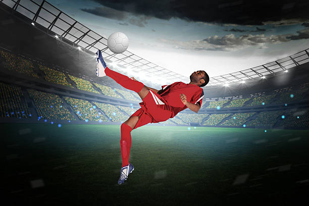 istock Football player in red kicking 489220669