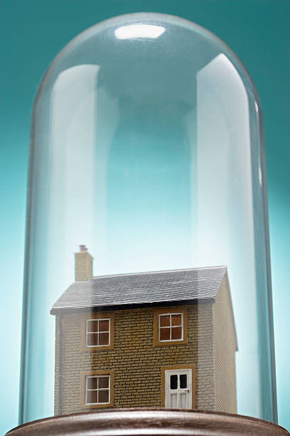 istock Small model house under glass cover 489223043