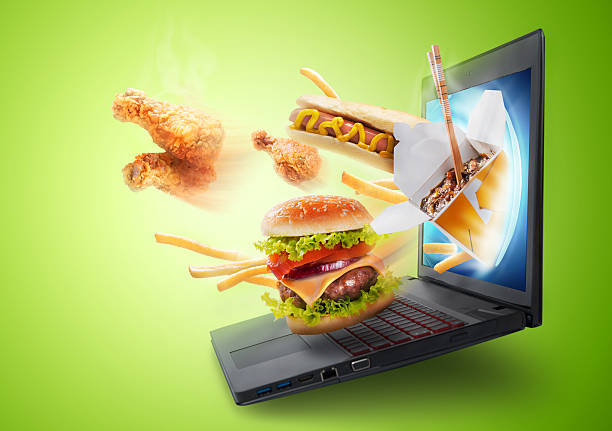 Food flying out of a laptop screen stock photo
