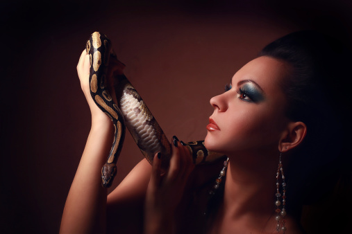 Portrait of Beautiful Woman in studio with dangerous snake