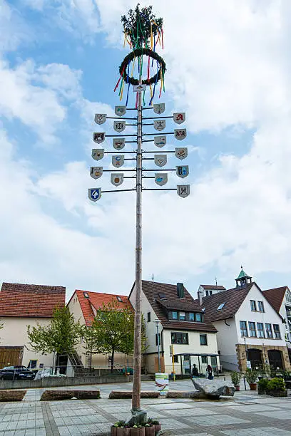 OSTFILDERN-SCHARNHAUSEN, GERMANY - MAY 1, 2014 - A newly decorated and mounted maypole with plaques representing the various professions and crafts of the town celebrating the May Day on May, 1,2014 in Ostfildern-Scharnhausen near Stuttgart, Germany.