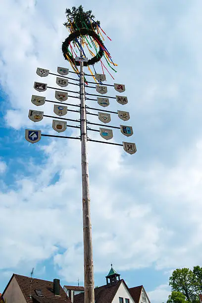 OSTFILDERN-SCHARNHAUSEN, GERMANY - MAY 1, 2014 - A newly decorated and mounted maypole with plaques representing the various professions and crafts of the town celebrating the May Day on May, 1,2014 in Ostfildern-Scharnhausen near Stuttgart, Germany.