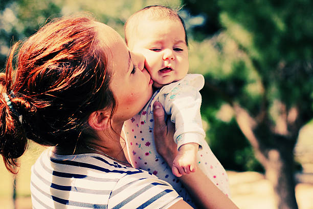 Portrait of happy loving mother and her baby outdoors