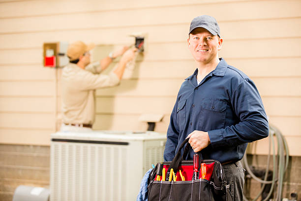 istock Air conditioner repairmen work on home unit. Blue collar workers. 489242862