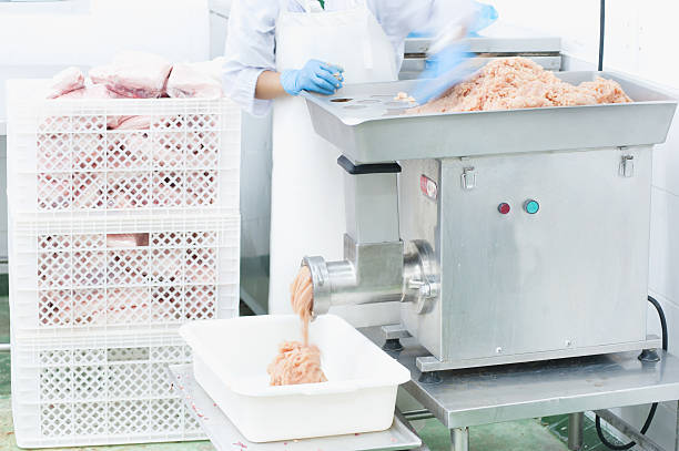 istock worker mincing meat at  butcher shop 489243524