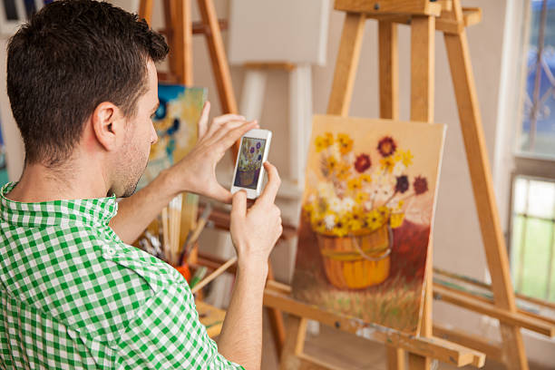 Taking a photo of his art