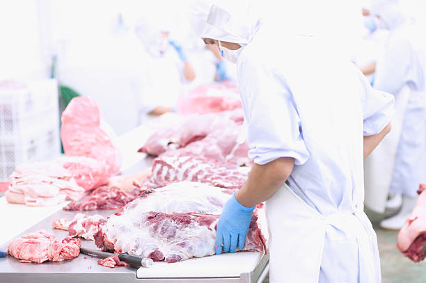 istock butcher cutting meat on the table 489244844
