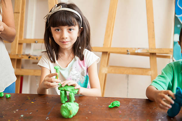 istock Cute girl sculpting with clay 489244852