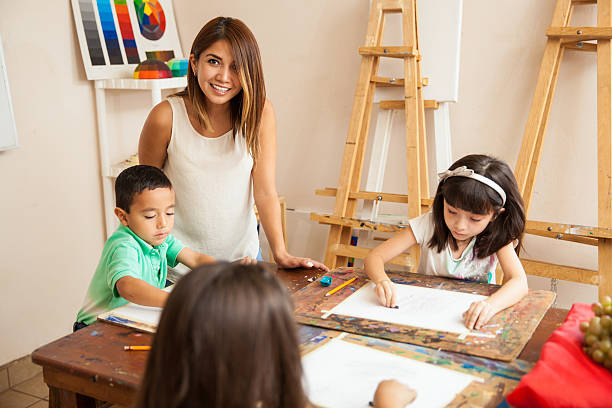 istock Happy art teacher in class 489245120