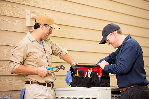 istock Air conditioner repairmen work on home unit. Blue collar workers. 489247006