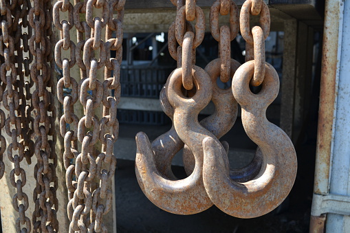 Heavy metal lifting hooks and chains used in a seafood production factory processing oysters in bulk. 