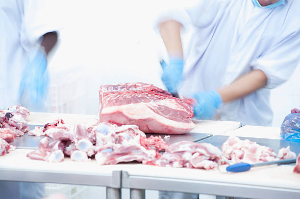 istock butcher cutting meat on the table 489247972