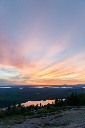 the stunning sunset reflects in the lakes that lie below Cadillac Mountain in Acadia National Park, on the east coast of the USA