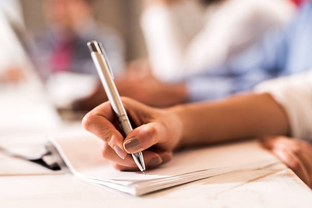 istock Unrecognizable person writing on a piece of paper. 489250368