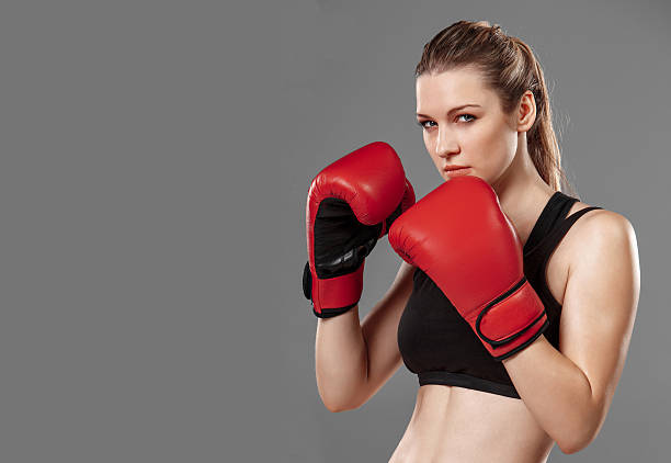 istock beautiful woman is boxing on gray background 489250640