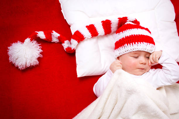 istock Sleepy baby on red blanket 489250682