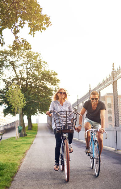 istock Romantic couple cycling holding hands 489251064