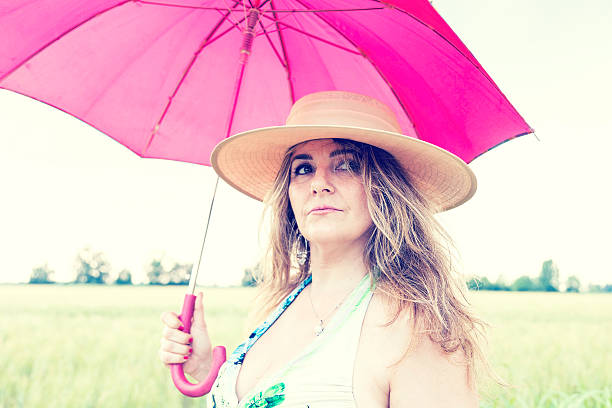 istock beautiful lady walking on a path in the rain 489252940