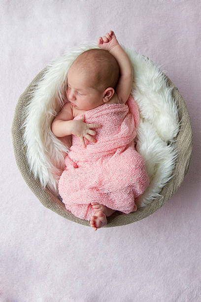 Newborn baby girl, 7 days old, sleeping stock photo
