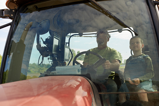 Shot of a young boy sitting with his dad inside the cab of a modern tractorhttp://195.154.178.81/DATA/i_collage/pu/shoots/805487.jpg