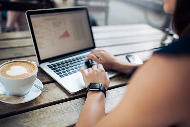 istock Woman at cafe working on her laptop 489255750