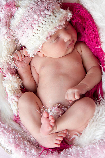 Newborn baby girl, 7 days old, sleeping stock photo