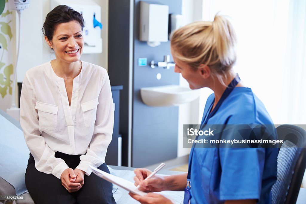 Female Patient And Doctor Have Consultation In Hospital Room Patient Stock Photo