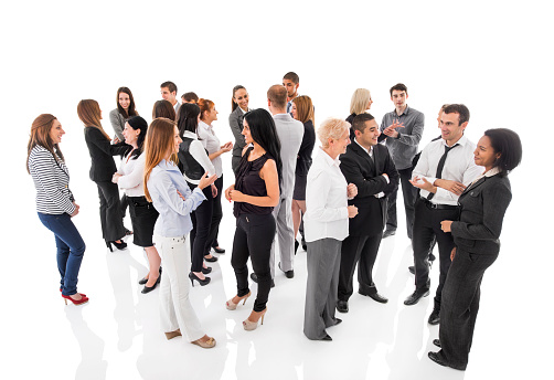 Large group of smiling business people standing together and discussing.  Isolated on white.